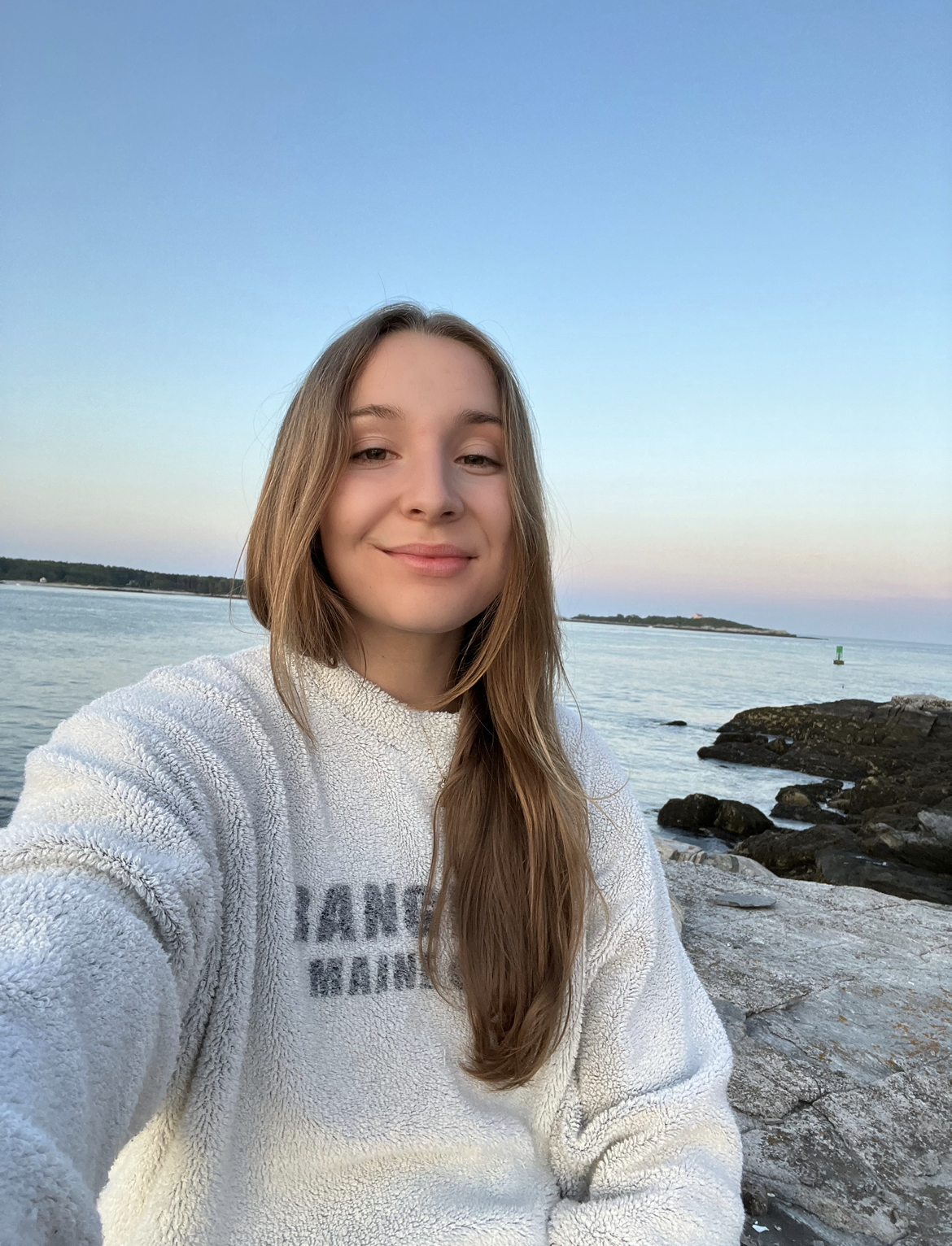 College-aged girl smiling at the beach.