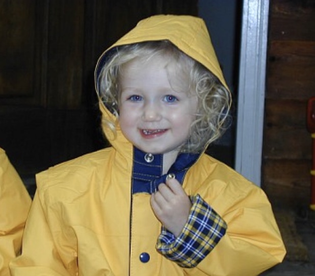 Little girl wearing a yellow raincoat.