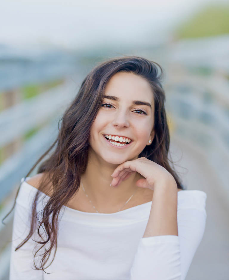 College-aged girl smiling at the camera.