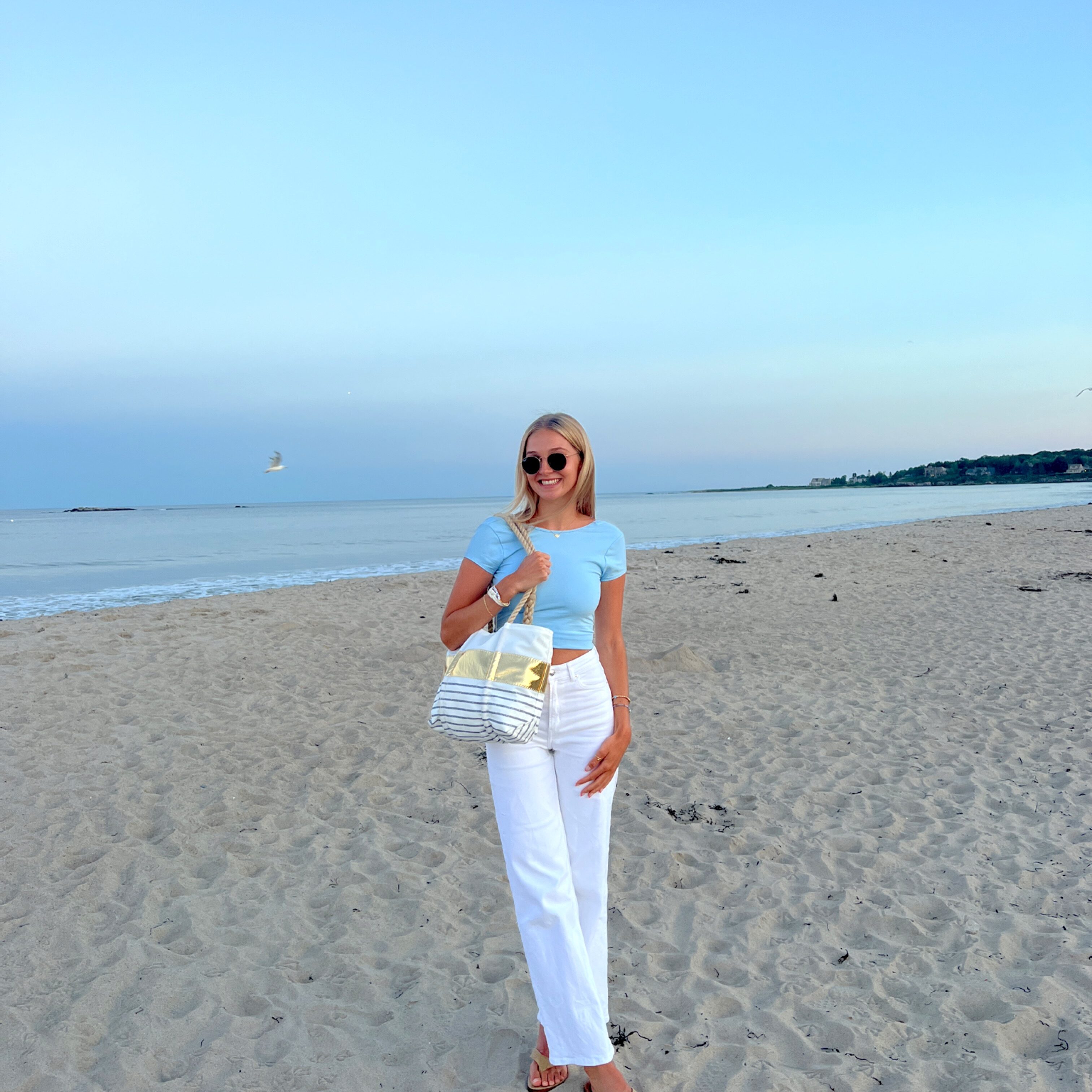 College-aged girl posing at the beach.