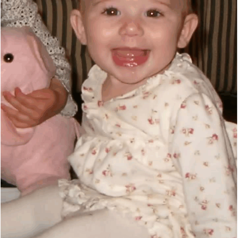 Little girl smiling for the camera.