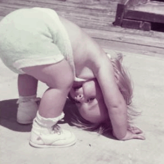 Little girl bent over in diaper.