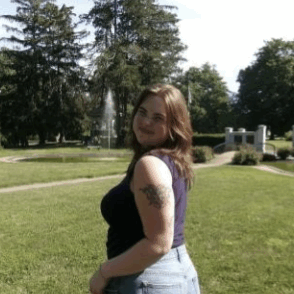 College-aged girl smiling in a park.