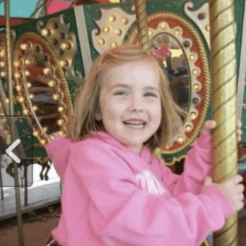 Little girl on a carousel.