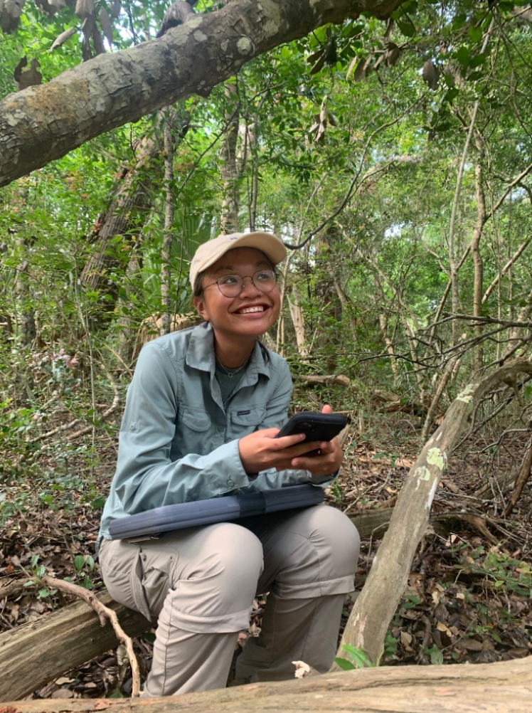 Khanh resting on a log in Bald Head Woods Reserve