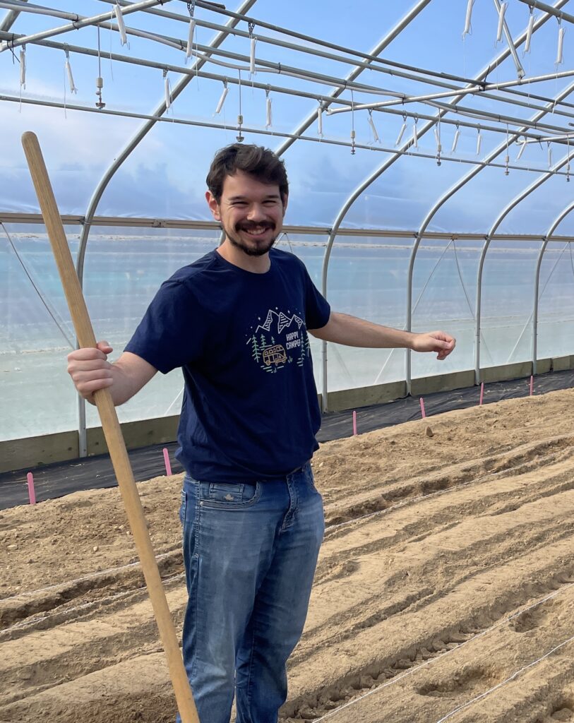 Kevin standing in a greenhouse